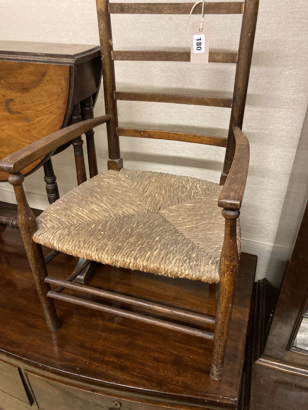 A late Victorian walnut Sutherland table, width 53cm height 56cm, together with a childs rush seat elbow chair
